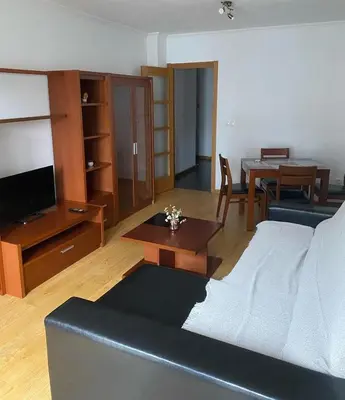 a living room with a couch and a table at Terra 3A in Caldas de Reis