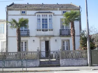 a white house with palm trees in front of it at Villa Andrade in Mor