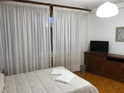 a bedroom with a bed and a flat screen tv at Hostal Costa Azul in Santiago de Compostela