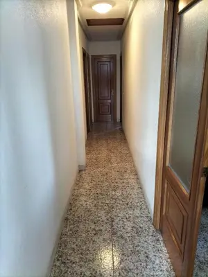 an empty hallway with a door and a tile floor at Casa familiar Sanabria in Ribadelago
