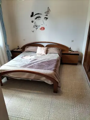 a bedroom with a bed with a face on the wall at Casa familiar Sanabria in Ribadelago