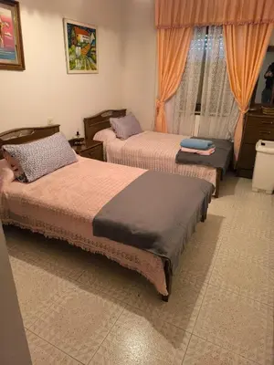 a bedroom with two beds and a window at Casa familiar Sanabria in Ribadelago