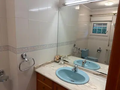 a bathroom with two sinks and a mirror at Casa Pepe Albela - 20 min de Santiago in Santiago de Compostela