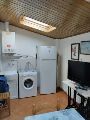 a kitchen with a refrigerator and a washer and dryer at Casa María in Ribadeo