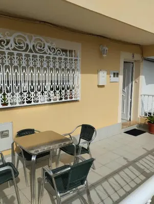 a table and chairs sitting on a patio at Casa María in Ribadeo