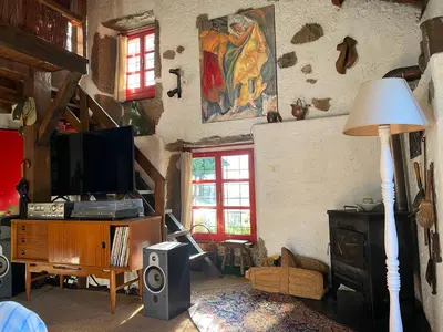 a living room with a television and a painting on the wall at O Freixo in A Capela