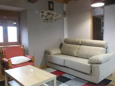 a living room with a couch and a table at Apartamentos Rurales Casa Llucas in San Julián