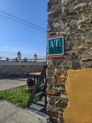 a sign on the side of a stone building at Apartamentos Rurales Casa Llucas in San Julián