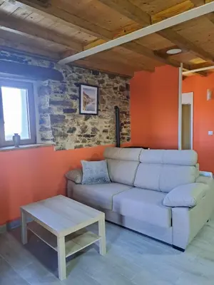 a living room with a couch and a table at Apartamentos Rurales Casa Llucas in San Julián