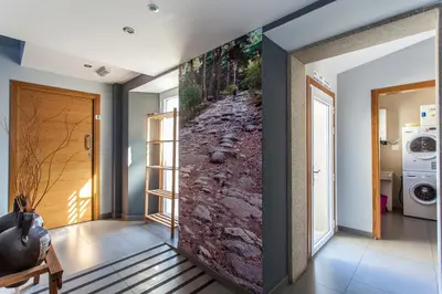 a living room with a wall mural of a river at Albergue Milpés in Ribadiso