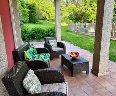a patio with wicker chairs and a table at Los Cedros in Cabañas