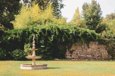 a fountain in the middle of a grass field at Cabaña familiar in Celanova