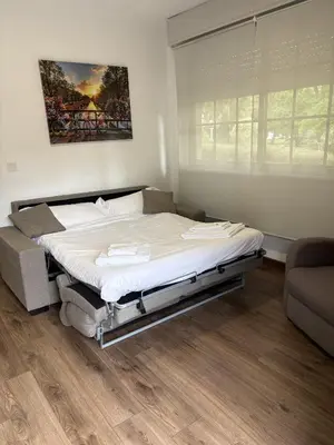 a bedroom with a large bed in a room at Cabaña familiar in Celanova