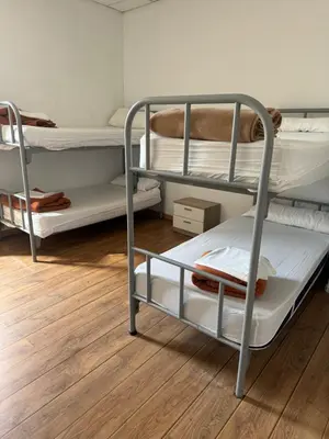 two bunk beds in a room with a wooden floor at Roots and Boots in Lugo