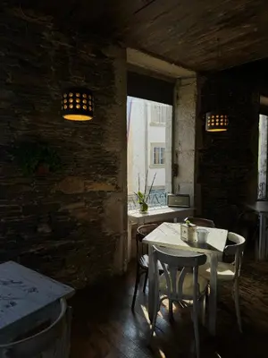 a dining room with a table and chairs and a window at Roots and Boots in Lugo