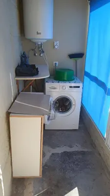 a kitchen with a washing machine in a room at Casa Diaz in Cea