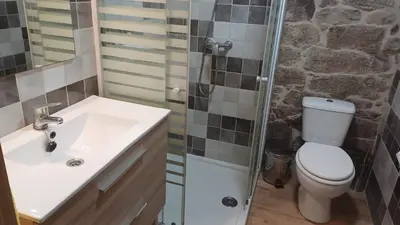 a bathroom with a toilet and a sink and a shower at Casa Diaz in Cea
