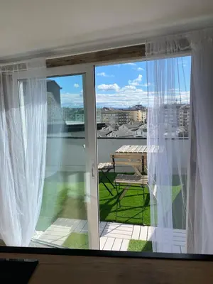 a window with a view of a balcony at El ático de la terraza in Lugo