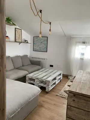 a living room with a couch and a coffee table at El ático de la terraza in Lugo