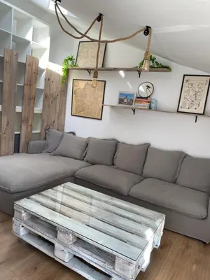 a living room with a couch and a coffee table at El ático de la terraza in Lugo