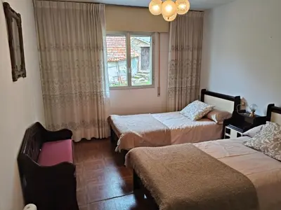 a hotel room with two beds and a window at Casa rural con amplio terreno privado in Irijoa