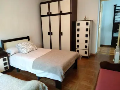 a bedroom with two beds and a dresser at Casa rural con amplio terreno privado in Irijoa