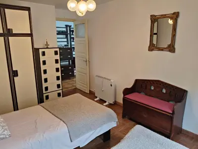 a bedroom with a bed and a chair and a mirror at Casa rural con amplio terreno privado in Irijoa