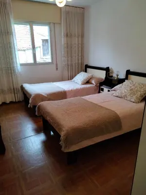 a room with three beds and a window at Casa rural con amplio terreno privado in Irijoa