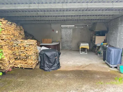 a garage with a pile of wood in it at Casa rural con amplio terreno privado in Irijoa