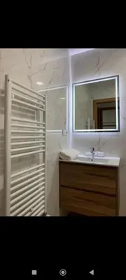 a bathroom with a sink and a mirror and a shower at Pensión Castineiras in Sarria