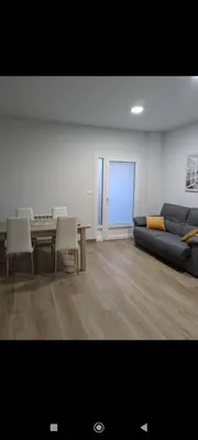 a living room with a couch and a table at Pensión Castineiras in Sarria