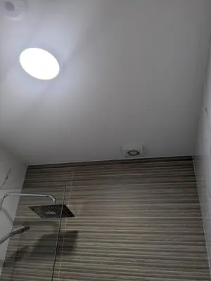 a bathroom with a shower with a light on the ceiling at Pensión Castineiras in Sarria