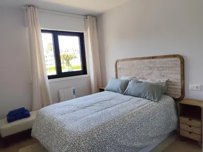 a bedroom with a bed and a window at Apartamento a 400m de la playa en Ares, garaje incluído in Ares