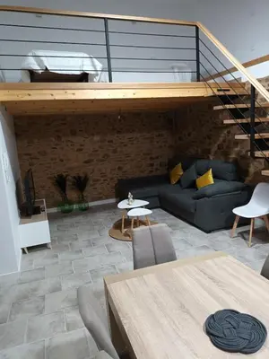 a living room with a couch and a staircase at Él Rincón de los Sueños B in Vegadecabo