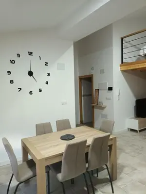 a dining room with a table and a clock on the wall at Él Rincón de los Sueños B in Vegadecabo