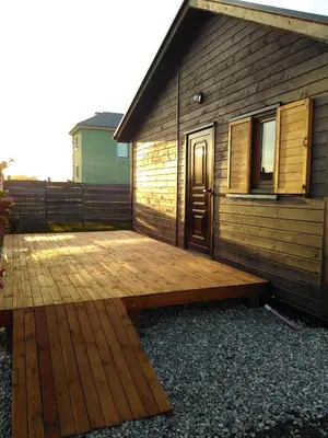 a wooden deck in front of a building at Villas Eldorado-Mascotas Bienvenidas in Barreiros