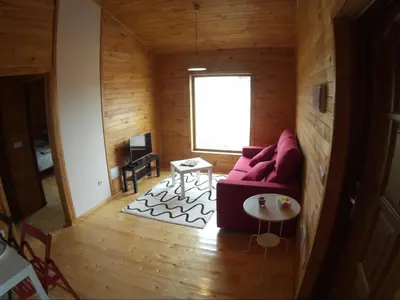 a living room with a red couch and a table at Villas Eldorado-Mascotas Bienvenidas in Barreiros