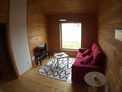 a living room with a red couch and a table at Villas Eldorado-Mascotas Bienvenidas in Barreiros