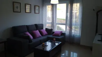 a living room with a couch and a coffee table at 2 habitaciones piscina y garage privado in Viveiro