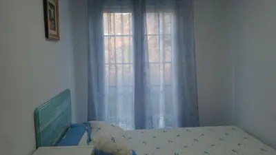 a bedroom with a bed and a window at 2 habitaciones piscina y garage privado in Viveiro