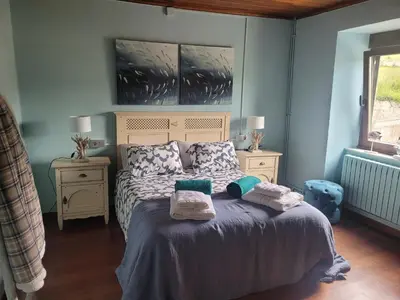 a bedroom with a bed with towels on it at O Salgueiral Xove in Jove