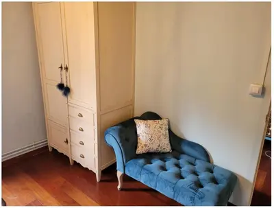 a blue couch with a pillow sitting in a room at O Salgueiral Xove in Jove