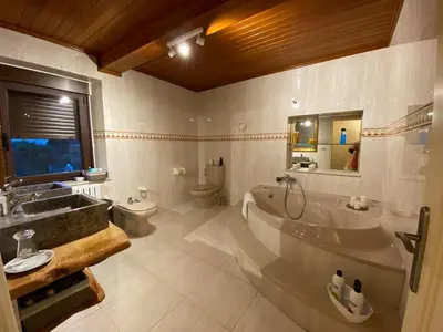 a bathroom with a tub and a sink and a toilet at O Salgueiral Xove in Jove