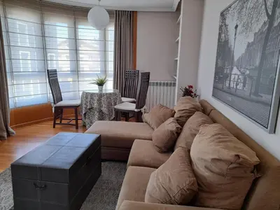 a living room with a couch and a table at Apartamento Camino de Santiago in Ordes
