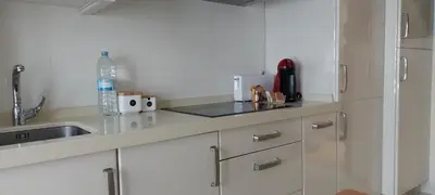 a kitchen with a sink and a counter top at Apartamento Camino de Santiago in Ordes