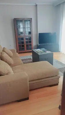a living room with a couch and a table at Apartamento Camino de Santiago in Ordes
