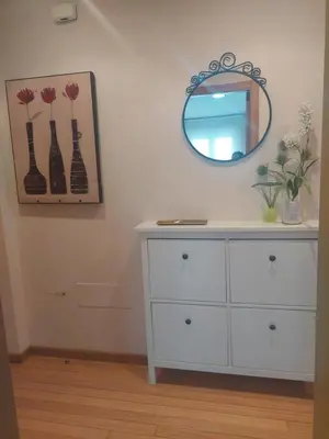 a white dresser in a room with a mirror at Apartamento Camino de Santiago in Ordes
