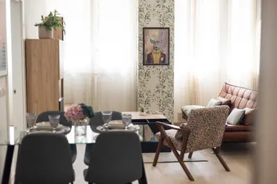 a living room with a table and chairs at Camino Termal OURENSE in Valenzana