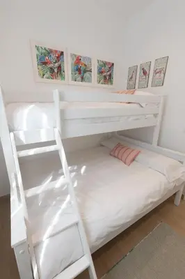 a white bunk bed with a ladder in a room at Camino Termal OURENSE in Valenzana