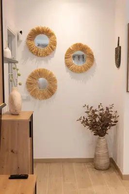 four wreaths on a wall with a vase at Camino Termal OURENSE in Valenzana
